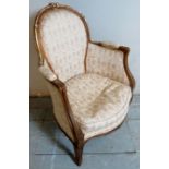 A small 20th Century French style gilt wood framed armchair upholstered in a floral material on