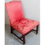 A 19th Century show wood chair upholstered in a red floral material and terminating on castors.