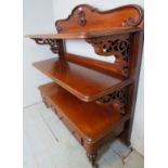 A large Victorian carved mahogany three tier buffet table with decorative carved upright supports