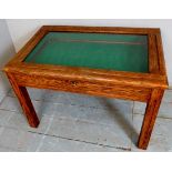 A 20th Century oak display case / coffee table with a glass inset top to lift up lid revealing a