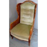 A large bamboo and whicker armchair with pale green upholstery to back and seat with additional