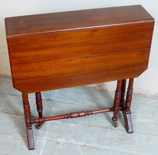 A small 19th Century mahogany drop leaf Sutherland table terminating on turned upright supports