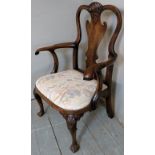 A fine 19th Century carved mahogany library chair with a carved back splat over decorative scroll