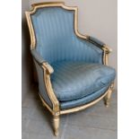 A French style show wood armchair upholstered in a blue striped material and with a white painted