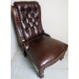 A Victorian mahogany framed library chair upholstered in button backed brown leather and