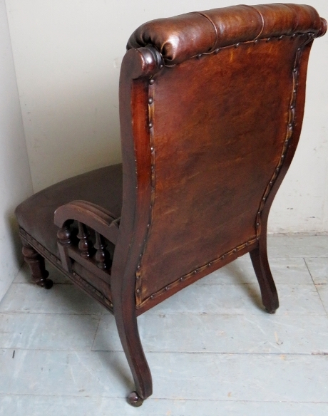 A Victorian mahogany framed armchair upholstered in brown button backed leather, - Image 3 of 4