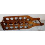 A novelty carved mahogany wine rack in the form of a large wine bottle,