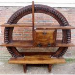 A fantastic large Brazilian mill wheel converted into a side unit with an assortment of shelves and