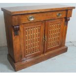 A 19th Century chiffonier sideboard with a single long drawer over two cupboard doors with inset