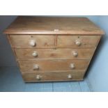 A Victorian pine chest of two short over three long graduated drawers with bun handles and of good