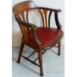 An oak framed captain's / smokers bow chair with a red leather upholstered seat over turned legs