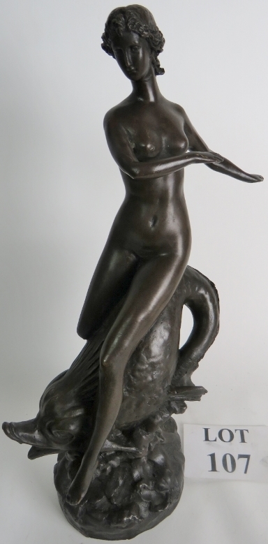 A patinated bronze statue of a female fi