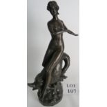 A patinated bronze statue of a female fi