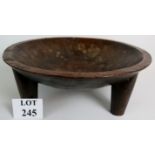 A large decorative antique ethnic hand carved ceremonial serving bowl, probably African,