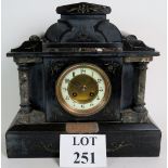 An Edwardian slate and marble striking mantel clock with enamel dial.