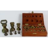 A boxed et of brass metric scale weights and a set of imperial brass bell weights, 11b to 1/4oz.