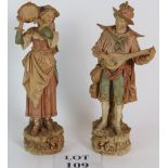 A pair of Bohemia Royal Dux figures depiction a lute player and tambourine player. Height is 33.5cm.