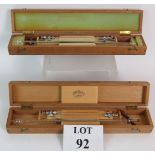 Two vintage surgical lumbar puncture kits in wooden cases, one marked 'Thackray, Leeds'.