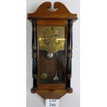 A late 19th/early 20th century oak case wall clock, with striking movement and brass dial.