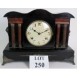 An antique faux slate striking mantel clock by Waterbury Clock Co, USA,