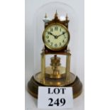 A domed brass anniversary clock, marker 'BHA', good quality movement under original glass dome.