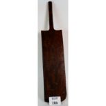 An antique oak over-sized cricket bat, 99cm long, 21cm wide. Condition report: Repaired handle.