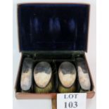 A leather cased 4 part gentleman's vanity case brush set with silver backs, monogrammed 'JH',