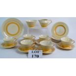 A Susie Cooper Art Deco part tea set of 21 pieces with graduated yellow banded decoration A/F.