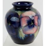 William Moorcroft vase, pansy pattern on blue background. Signed and incised marks. Height is 10cm.