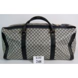 A large vintage Gucci travel holdall, in black and grey trellis design with leather trim.