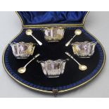 A good quality set of four salts with gilded interiors, London 1897, and four silver salt spoons,