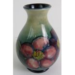 William Moorcroft bottle vase clematis pattern on green background, incised marks. Height is 11.5cm.