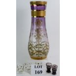 A tall glass vase with a floral pattern in silver & gilt clear at the base blending to purple at