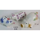 A hand decorated Arthur Woods pig money box and two similar. Largest: 14cm tall.