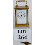 A French gilt brass carriage clock with key. Enamel dial with Roman numerals.