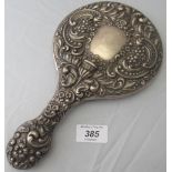 A heavily embossed silver hand mirror de