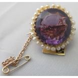 A large circular amethyst set brooch sur