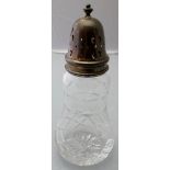 A modern cut glass sugar caster with sil