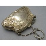 A silver embossed purse on a chain, deco