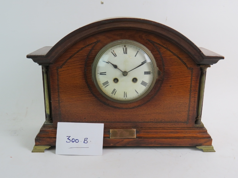 A French oak cased striking mantel clock