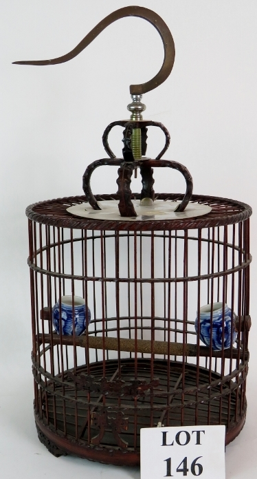 A decorative Chinese bird cage of carved