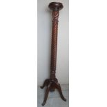 A 19th Century carved mahogany torchere