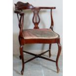 A late 19th Century carved corner chair