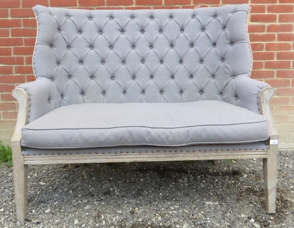 A contemporary high back two seater sofa