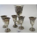 A Kiddush goblet embossed with buildings and grape vines,