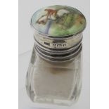 A glass smelling salts bottle, with associated silver and enamelled top,