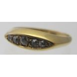 A graduated five stone diamond set ring, possibly 18ct gold, size K, small circular leather case.