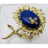 A fine quality 18ct yellow gold sunflower brooch by Chaumet, set with a large lapis lazuli stone,