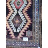 An unusual Luri rug on black ground with colourful central pattern. 1.92 x 1.20.