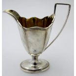 A silver helmet shaped jug on a oval base, gilded interior, London 1894, makers T B,